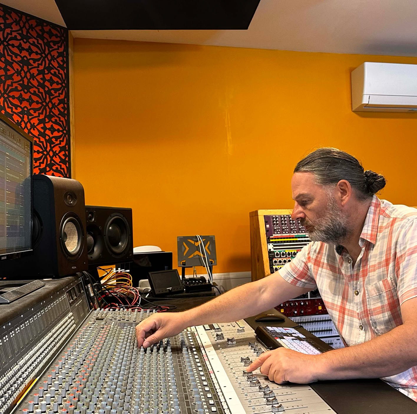 Oastview Studio's sound engineer mixing a song.